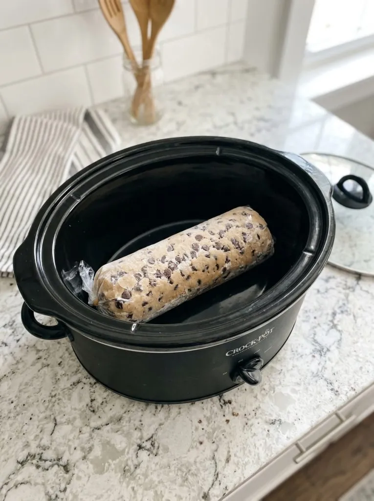 Toss a frozen raw cookie dough log in the slow cooker and 3 other ingredients to get a treat so delicious your family will be begging for more!