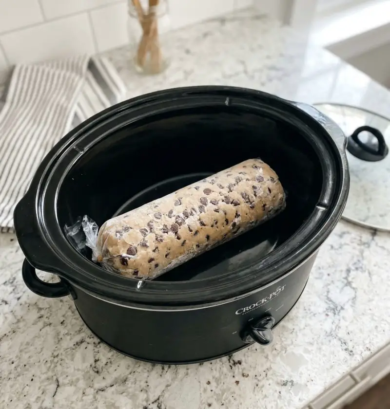 Toss a frozen raw cookie dough log in the slow cooker and 3 other ingredients to get a treat so delicious your family will be begging for more!