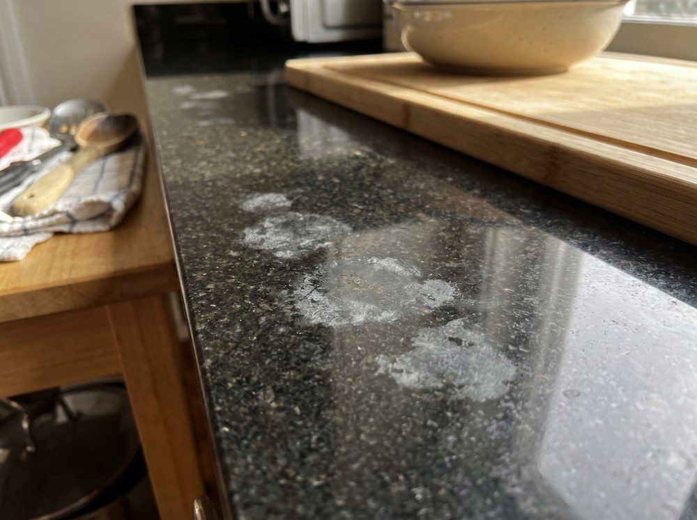 Dull etched patches on a granite countertop