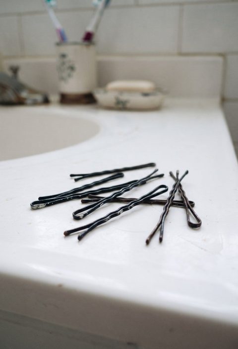 Bobby pins on a bathroom counter showing the wavy side