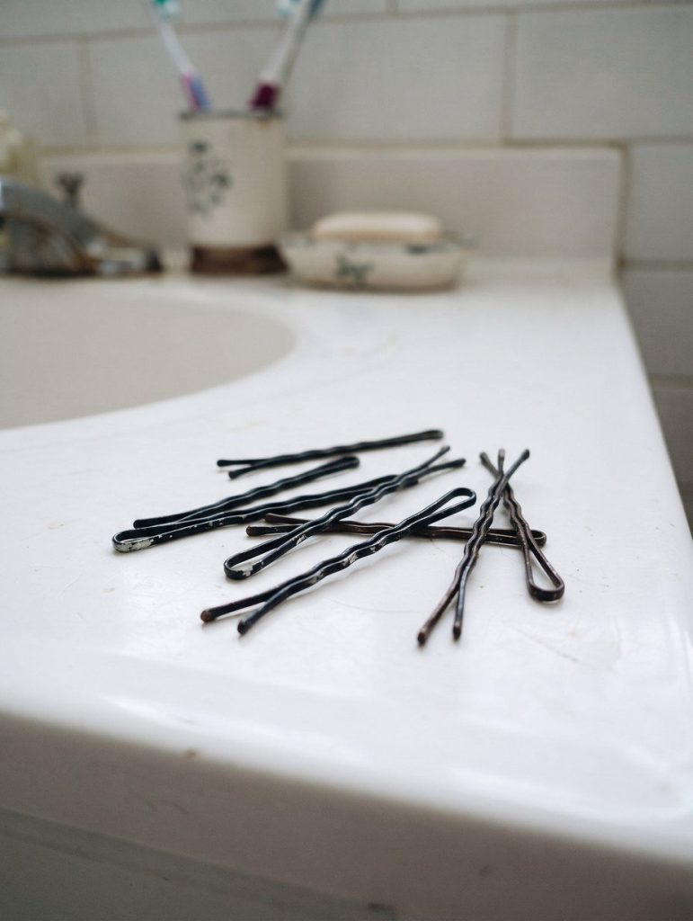 Bobby pins on a bathroom counter showing the wavy side