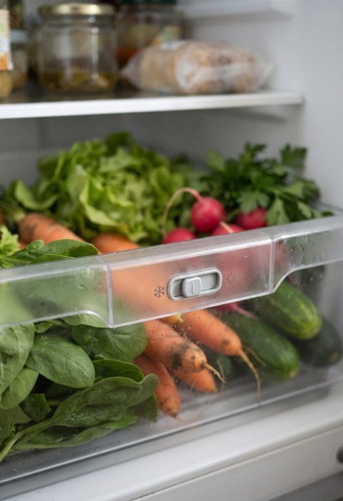 A refrigerator crisper drawer with its slider control visible