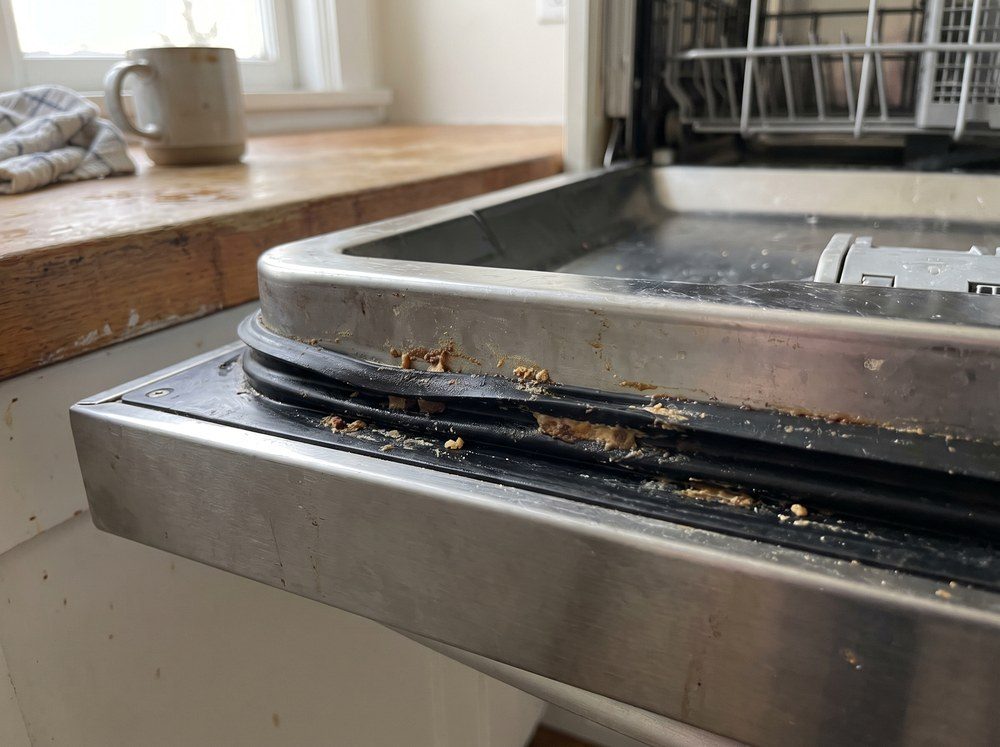 The rubber gasket around an open dishwasher door