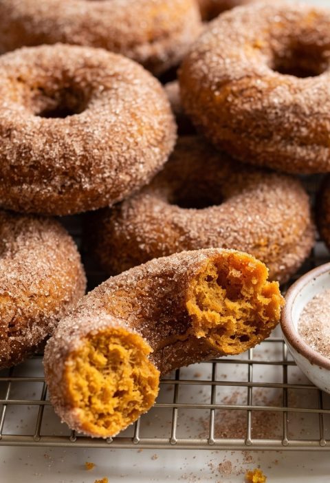 Baked pumpkin donuts rolled in cinnamon sugar