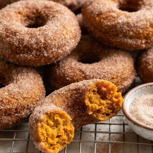 Baked pumpkin donuts rolled in cinnamon sugar