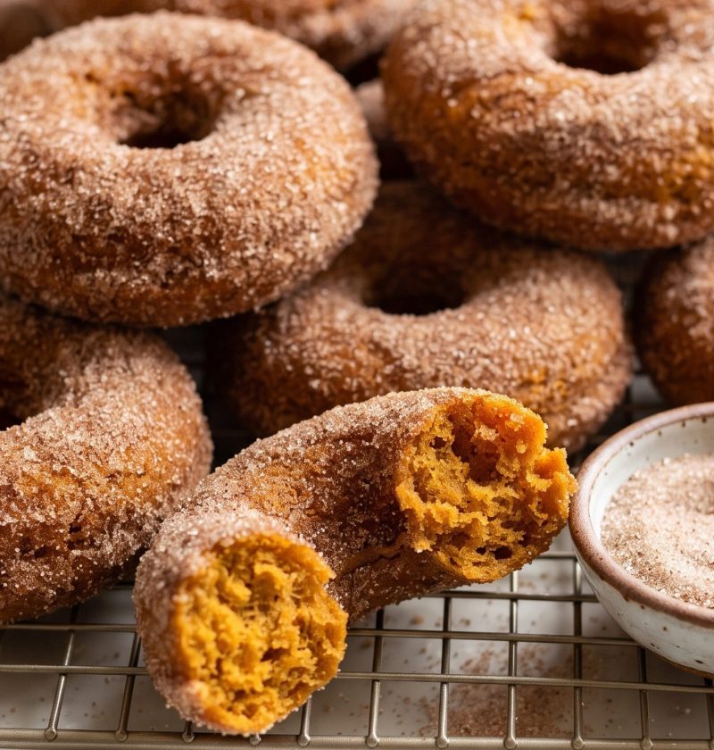 Baked pumpkin donuts rolled in cinnamon sugar