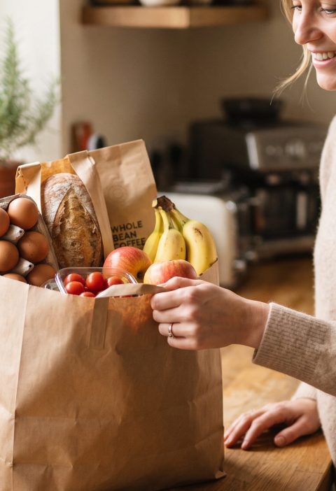 Grown son bringing groceries to his mom's house