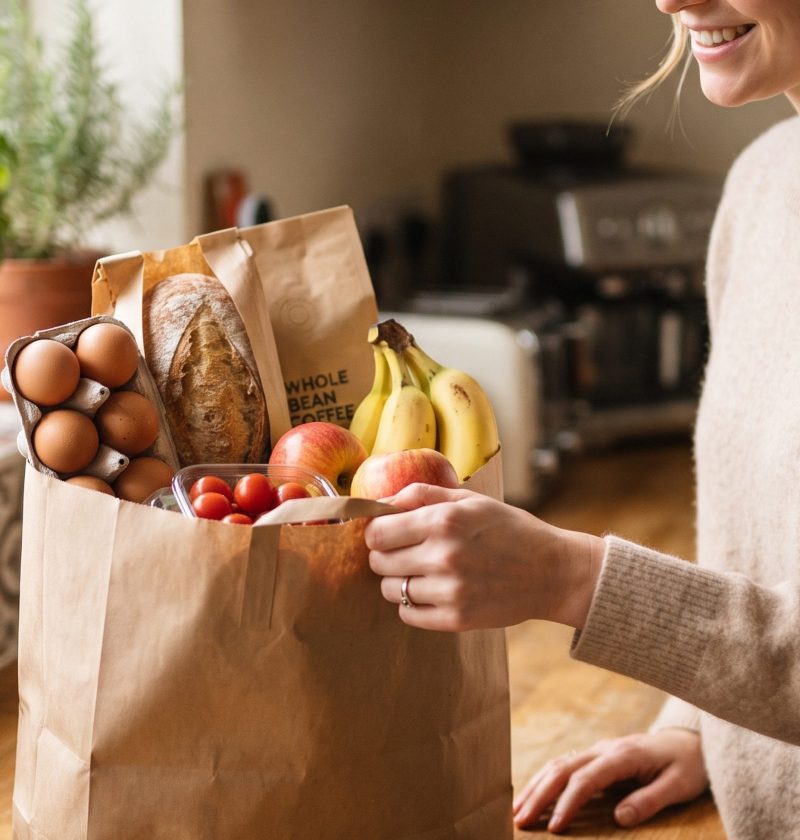 Grown son bringing groceries to his mom's house