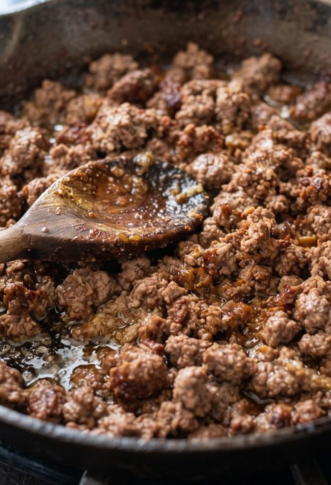 Browned ground beef with fat in the skillet