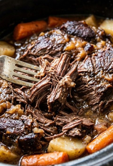 Tender pot roast pulled apart with a fork